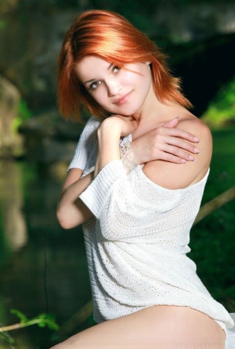 Beautiful redhead Violla A bares her young girl's body near a body of water 64218769