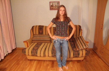 Nice teen Nika gets completely naked on a sofa by herself 14769168