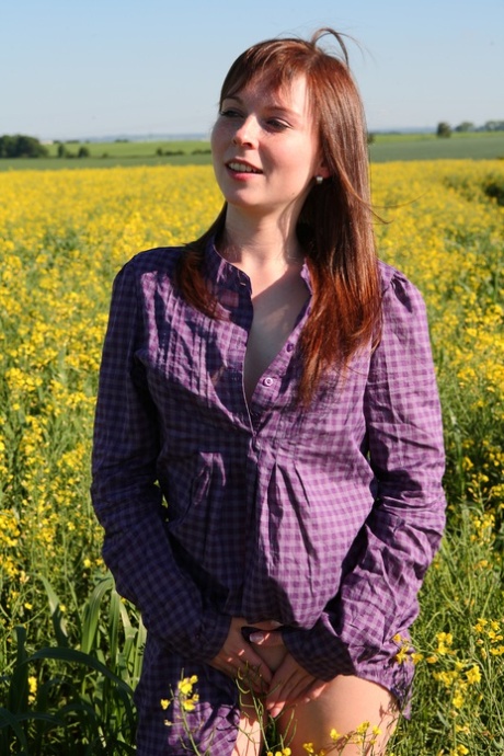 Young redhead Alka takes off her shirt to go naked in a field of rapeseed 36663097