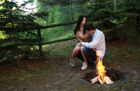 Young couple have sexual intercourse next to an outdoor fire pit 96486046
