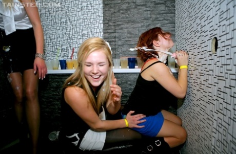 Party girls get showered with fresh cum through the club bathroom gloryhole