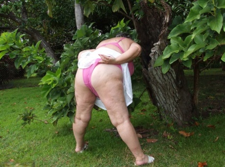 Obese British lady Grandma Libby exposes her large tits underneath a tree 15002094