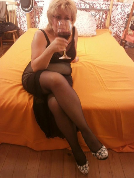 Tipsy hot granny Caro spreading legs on the bed wearing black stockings 84545003