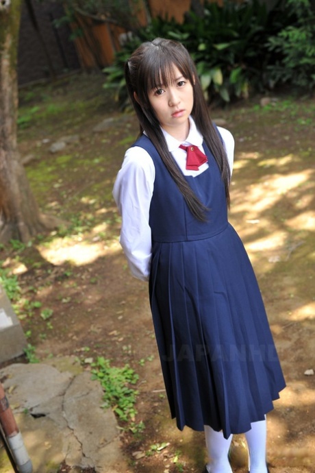 Charming Japanese babe posing in her cute school outfit in the garden 79573171
