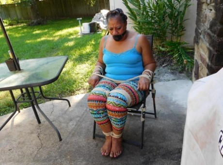 Black woman is left tied to a patio chair while gagged as well 30323862