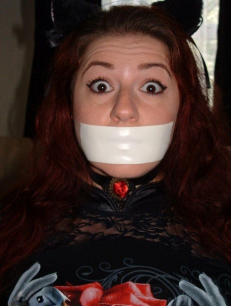 Thick redhead is tied to a chair with tape affixed to her mouth 17774739