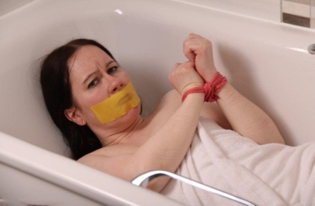 Caucasian girl is left gagged and tied up while in a bathtub 80840432