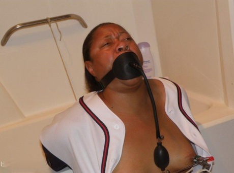 Ebony plumper is silenced with a pump up gag while restrained in a bathroom 49025919