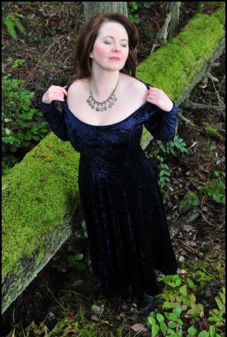 Mature woman Tasty Trixie heads into the woods to flash in a long velvet dress 63332146