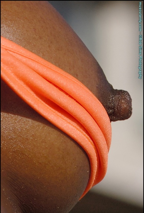 Ebony bodybuilder Victoria Dominguez lets her tits free of a bikini on a beach 92804768
