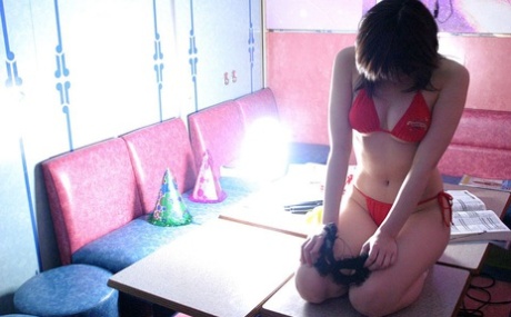 Japanese coed Hina Tachibana removes her uniform while wearing a red bikini