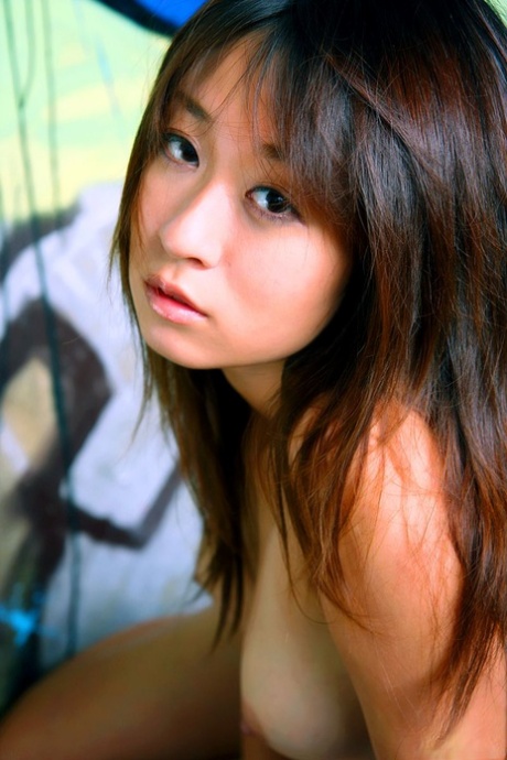 Japanese beauty Risa Misaki gets totally naked in a graffiti strewn building