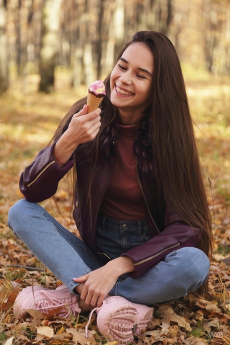 Nice Russian girl Leona Mia eats an ice cream treat in a forest while clothed 41998463