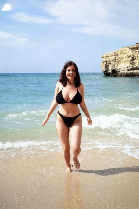 Brunette MILF Lorna Morgan releases her nice melons from bikini on a beach 53439786