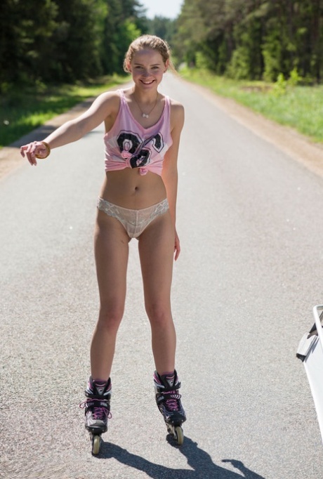 Young blonde girl Faina gets naked in middle of road wearing roller blades 63272591