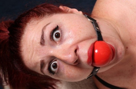 Thick redhead is hogtied in her lingerie while sporting a big ball gag 72740952