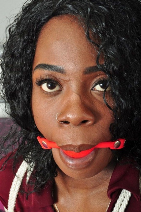 Ebony female is tied up on a bed while gagged and fully clothed 89500908
