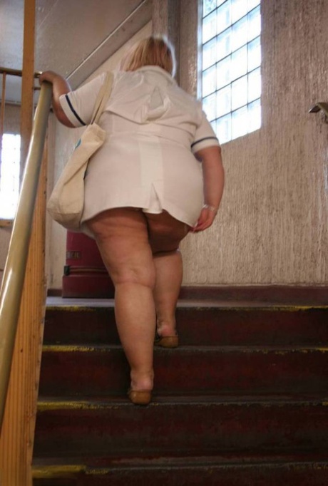 Fat older nurse Lexie Cummings exposes herself while walking on a sidewalk 19181649