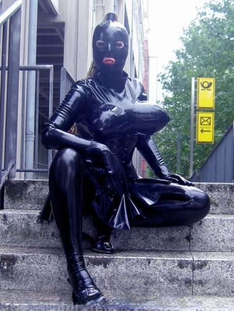 Caucasian woman wanders public streets while wearing rubber clothing 64247808