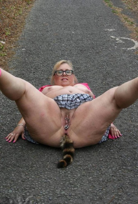 Fat UKwoman Lexie Cummings walks a path sporting a raccoon tail butt plug 97700901