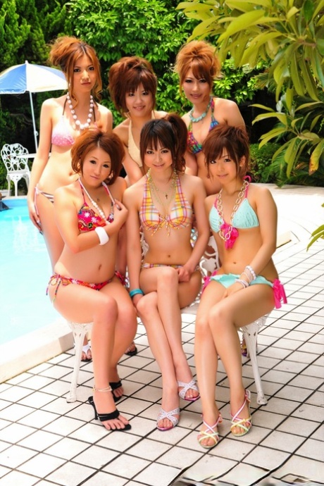 Japanese bikini models gather on a poolside patio for a group shoot 10204655