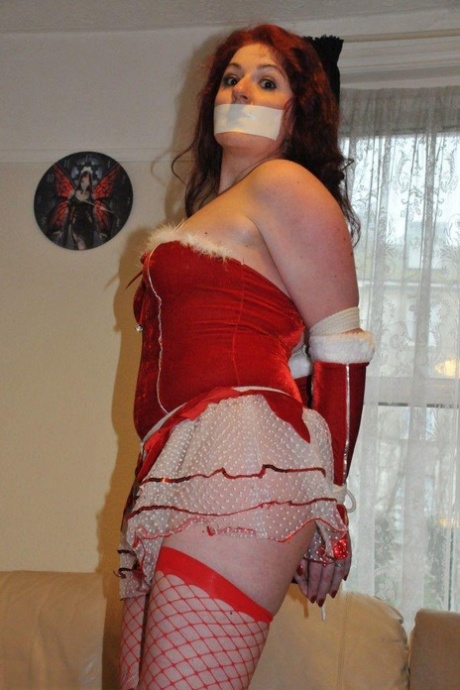 Redheaded solo girl shows her natural tits while restrained and gagged at Xmas 40602545