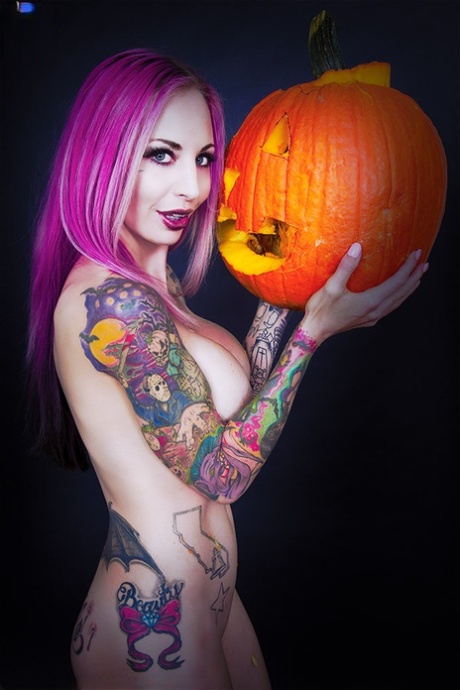 Tattooed chick Brandie Graves shows her fake tits while holding a pumpkin 51500132