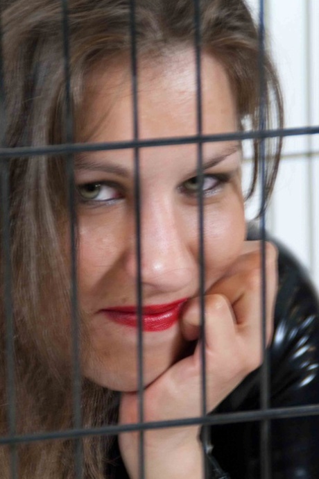 Jana Puff is locked away in a dog cage by a woman in head to toe latex attire 64943005