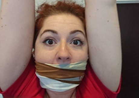 Redheaded woman is silenced with gags while restrained in her home 45579978