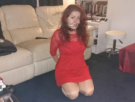 Redheaded female is gagged while wearing a collar and leash in a few outfits 88599203
