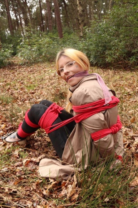 Natural redhead is left tied up and cleave gagged on dry leaves near the woods 69506580