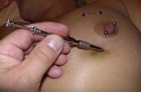 Close up action of a female having her breasts tortured with needles 79519411