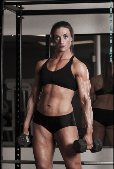 Bodybuilder Carrie Rapp models on a roadway before a weightlifting session 12208619