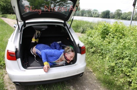 Caucasian girl is left in the boot of a vehicle while tied up and gagged 94027262