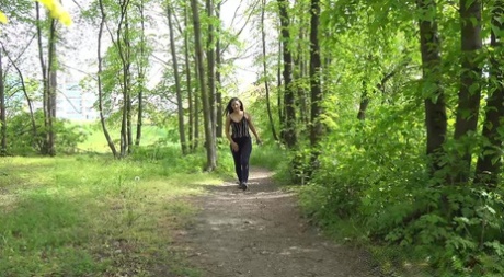 Pretty teen Nicolette Noir pulls down leggings to pee on a path in the woods 32278929