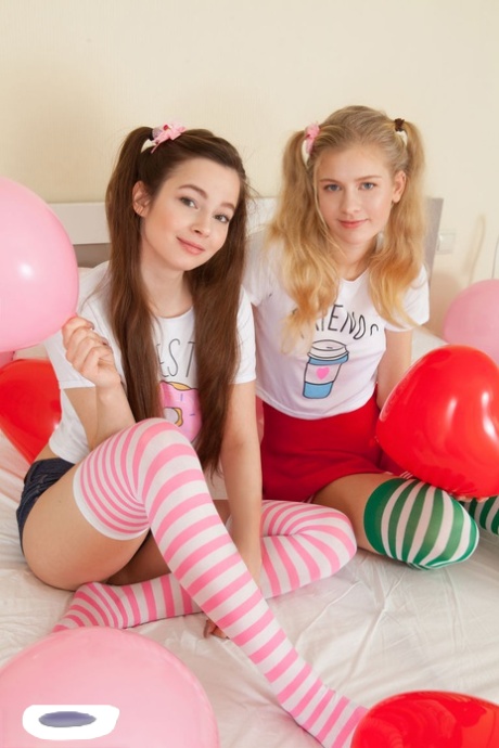 Young looking lesbians Amy & Angela remove their striped thigh highs together 78924342
