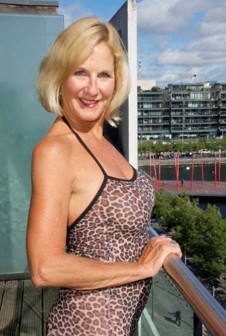 Older blonde woman Molly MILF exposes her tits and twat on condo balcony 75149486