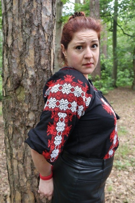 Thick redhead is cleave gagged and tied to a tree in a forest 16148455