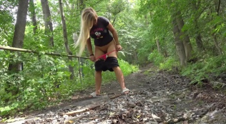 Solo girl Jena Lovely pulls down her shorts to piss on a path in the woods 93773051