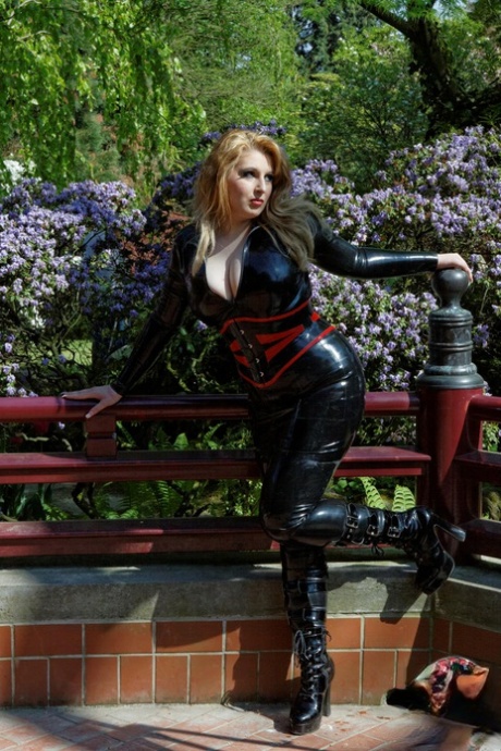 Natural redhead models on a expensive deck in black latex attire 70017544