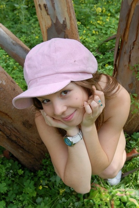 Charming young girl goes topless in the woods while wearing a funky hat 85498713