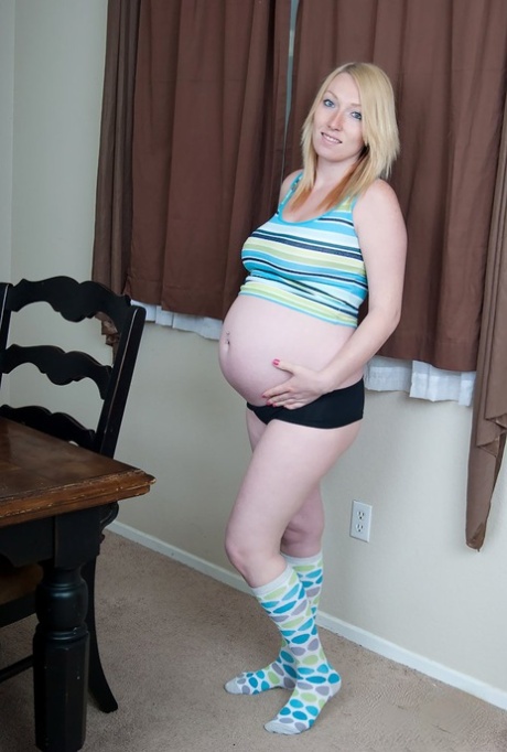 Pregnant blonde uncovers her milk filled tits while wearing knee socks 51104172