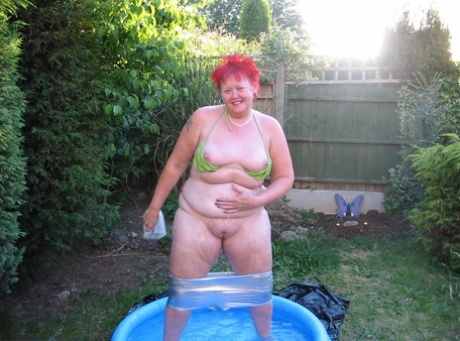 Older redheaded BBW Valgasmic Exposed plays with a dildo in a wading pool 35513020
