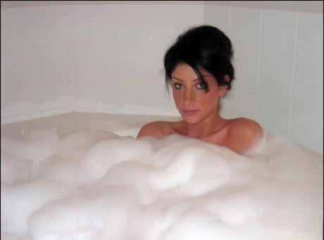 Brunette teen Carma takes a bubble bath in a teasing fashion 16884422