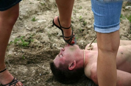 Cruel women trample and piss a submissive man during outdoor CFNM play