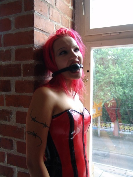 Solo girl with pink hair places a ball gag into her mouth during non-nude play 80697261