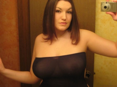 Curvy girl takes self shots in a mirror while wearing an off shoulder dress 16925015