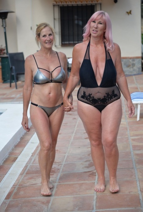 Mature BBW Melody and her girlfriend walk hand in hand by a pool in swimwear 37578629