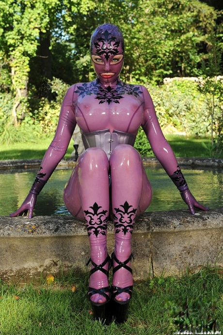 British solo girl Latex Lucy models latex clothing near a pond 47020971