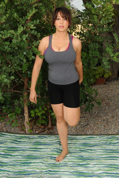 Mature MILF Lala Bond unleashes her hooters after outdoor yoga session 79381553